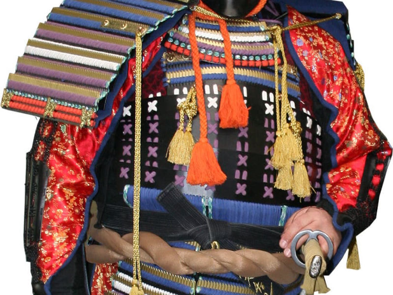 El amure rojo de samurái que lleva un practicante de artes marciales, con una katana